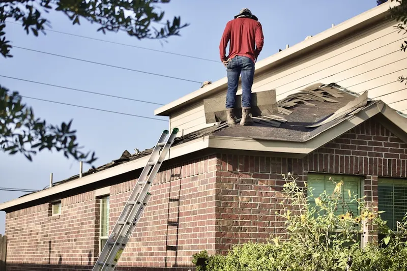 Professional roofer working on a residential roof in Fort Dodge